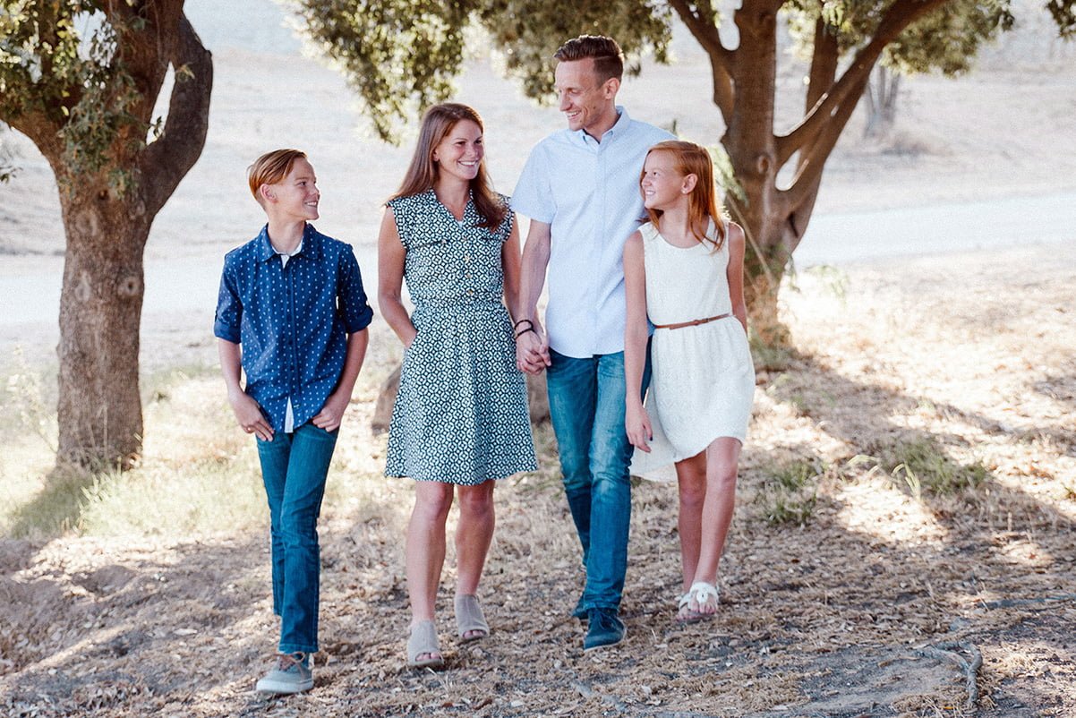 family walking in the country under trees