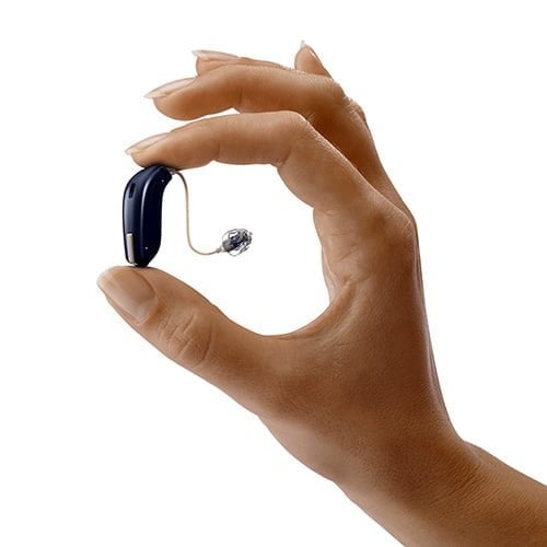 hand holding a receiver in the canal (RIC) hearing aid
